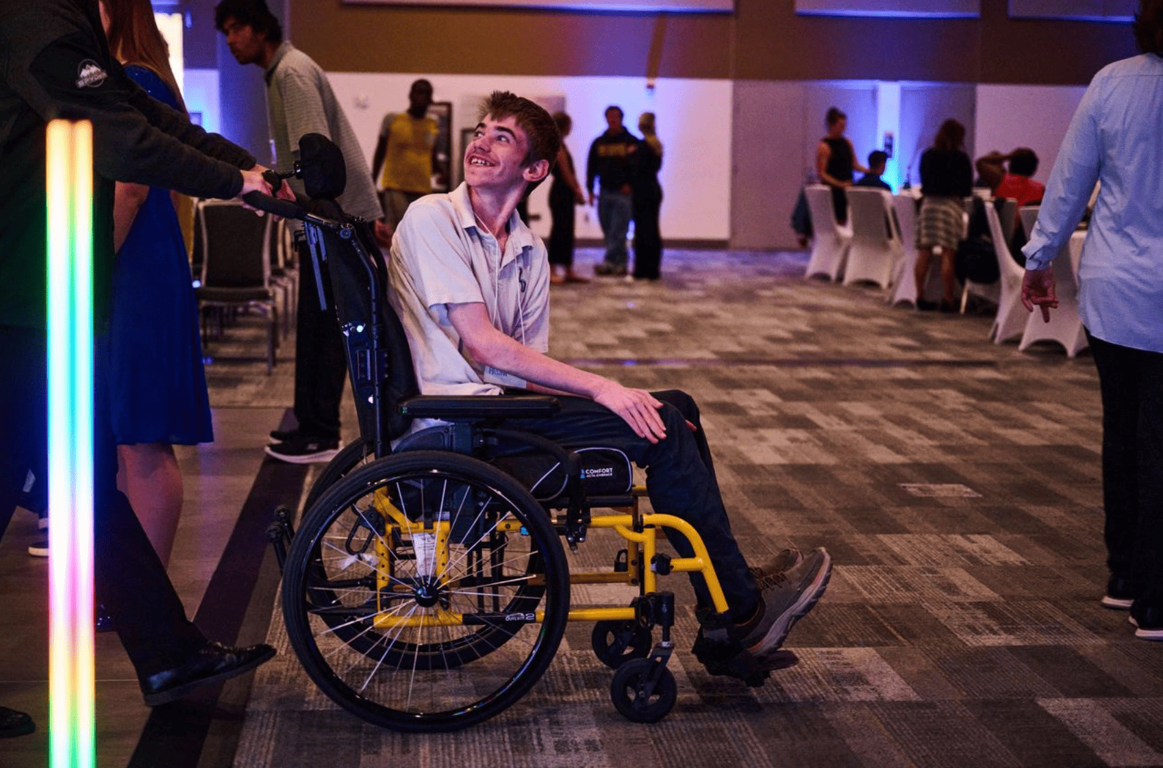 A wheelchair user chatting with other attendants at a prom party held at Rogers Centre